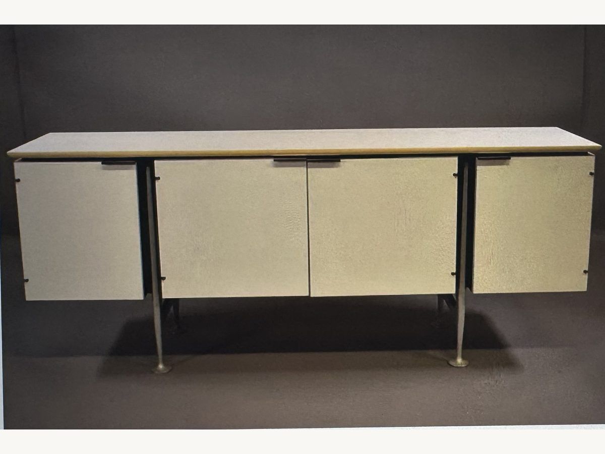 Alexander Girard credenza for Herman Miller with cream panel doors on slim metal legs
