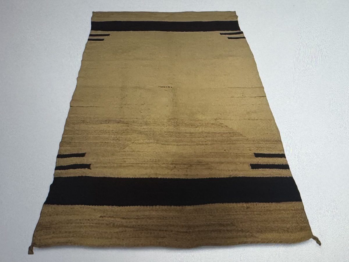 Large tan Navajo wool rug with dark banded stripes
