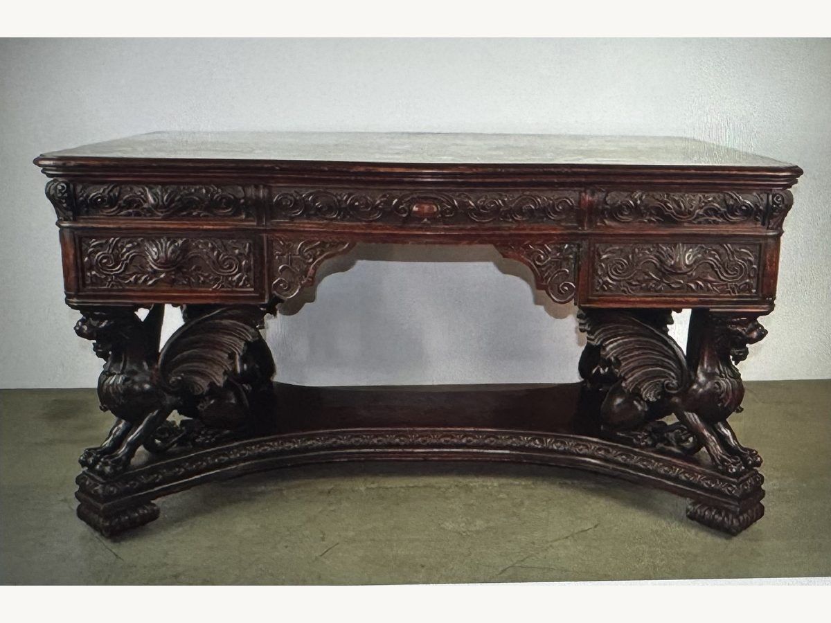 Heavily carved R.J. Horner oak desk with winged griffin supports